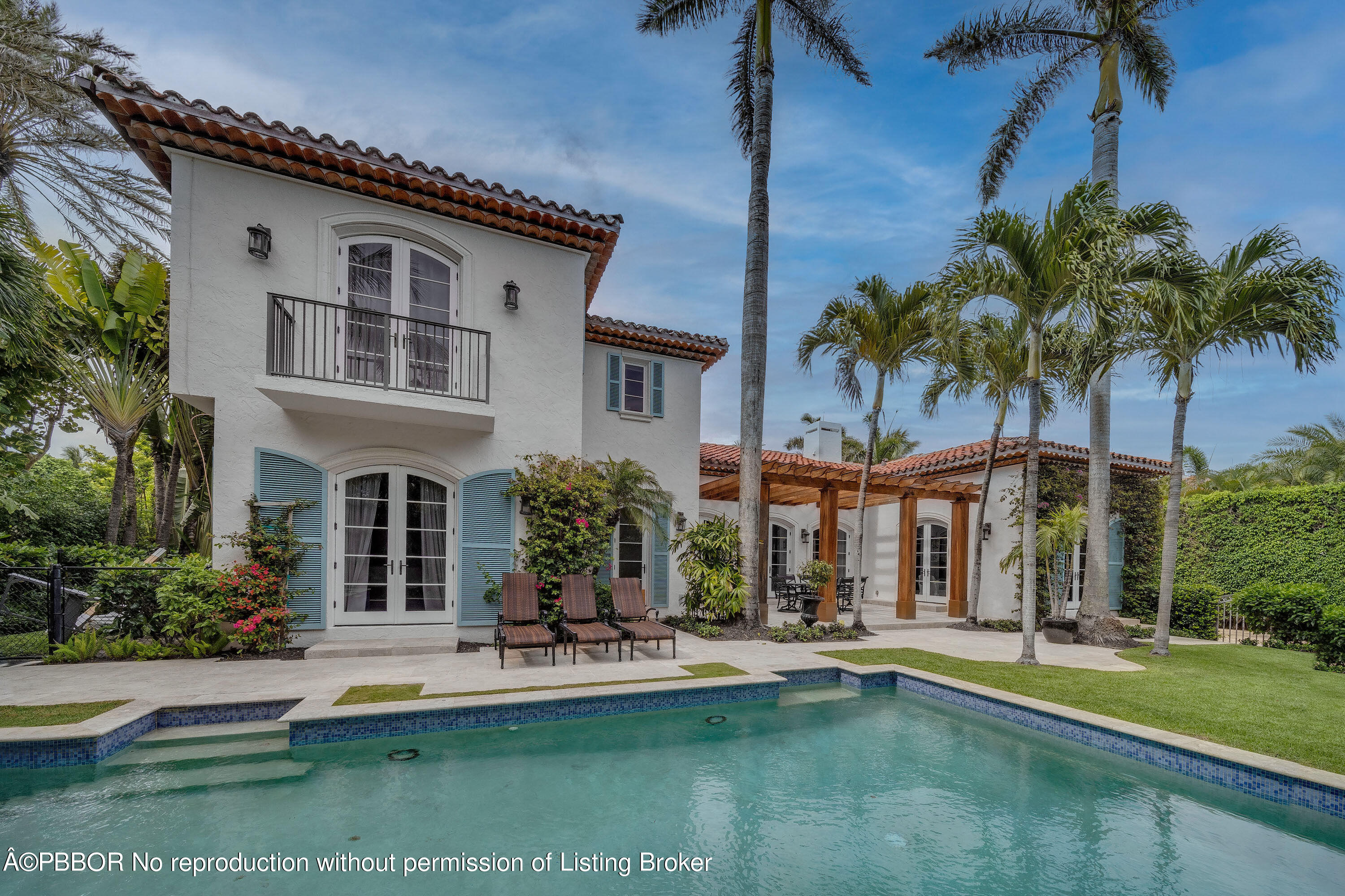 150 Woodbridge Road Palm Beach, FL 33480 - Photo 28 of 32 a front view of a house with swimming pool having outdoor seating