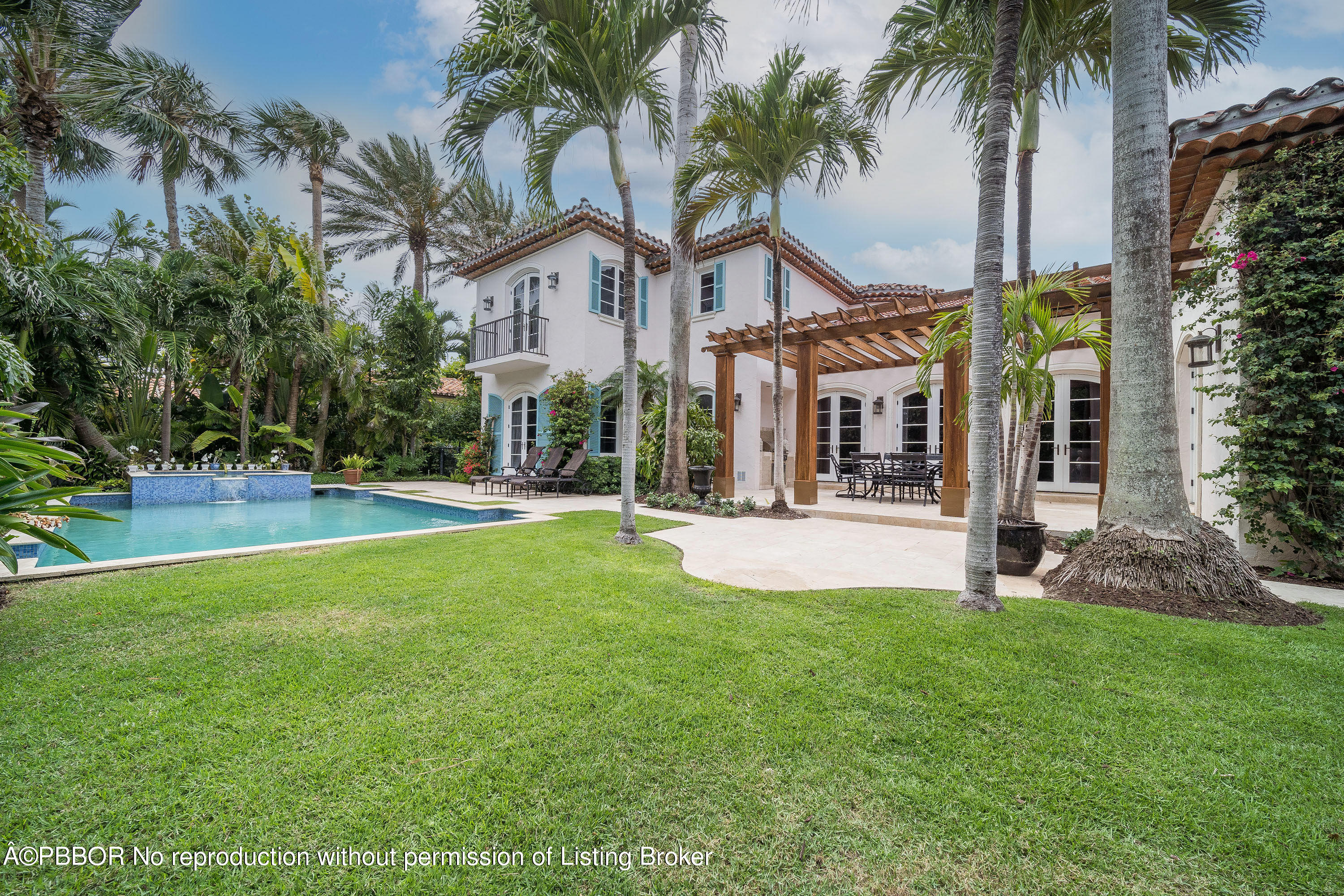 150 Woodbridge Road Palm Beach, FL 33480 - Photo 29 of 32 a view of a house with swimming pool and porch