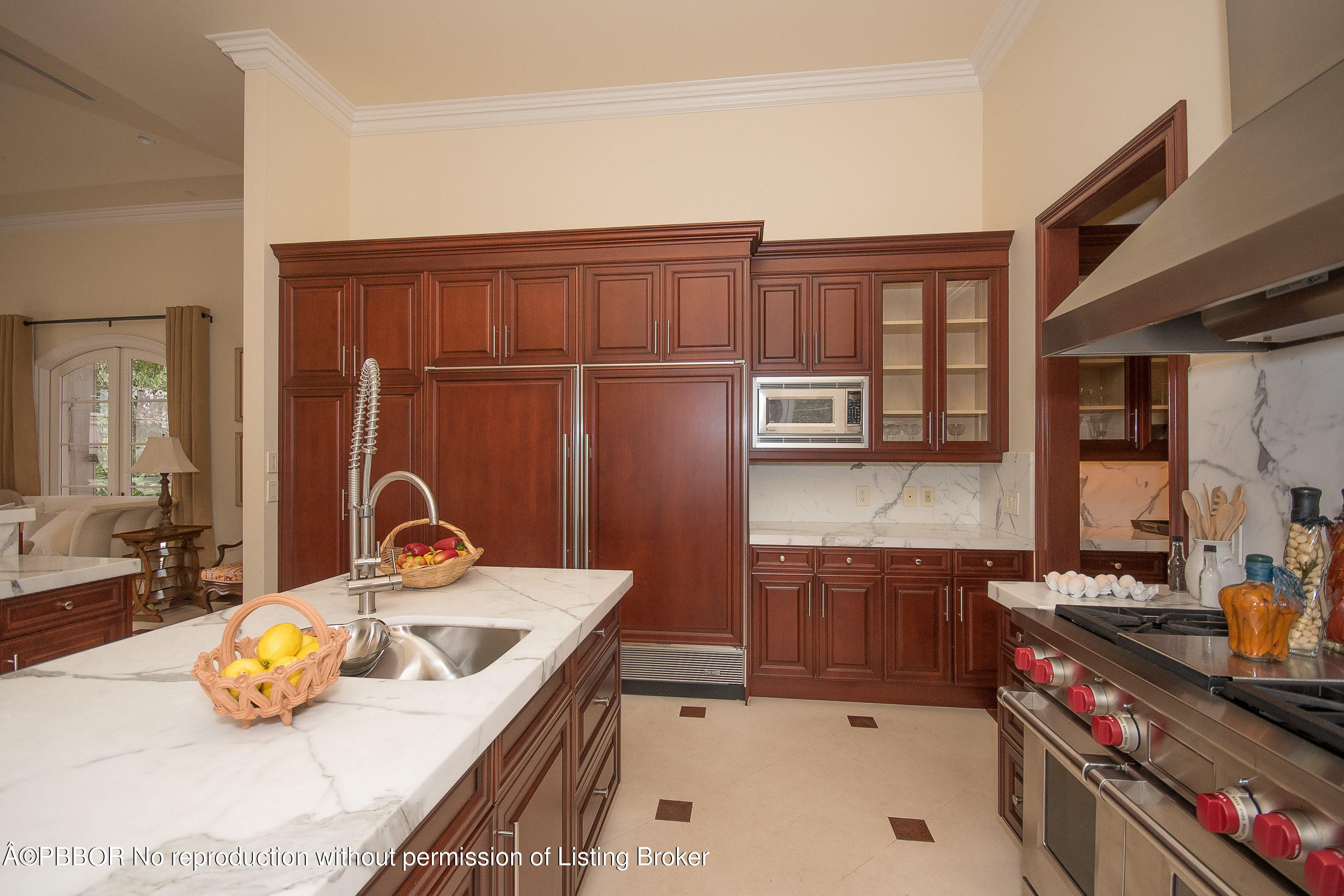 150 Woodbridge Road Palm Beach, FL 33480 - Photo 9 of 32 a kitchen with a sink a stove and wooden cabinets