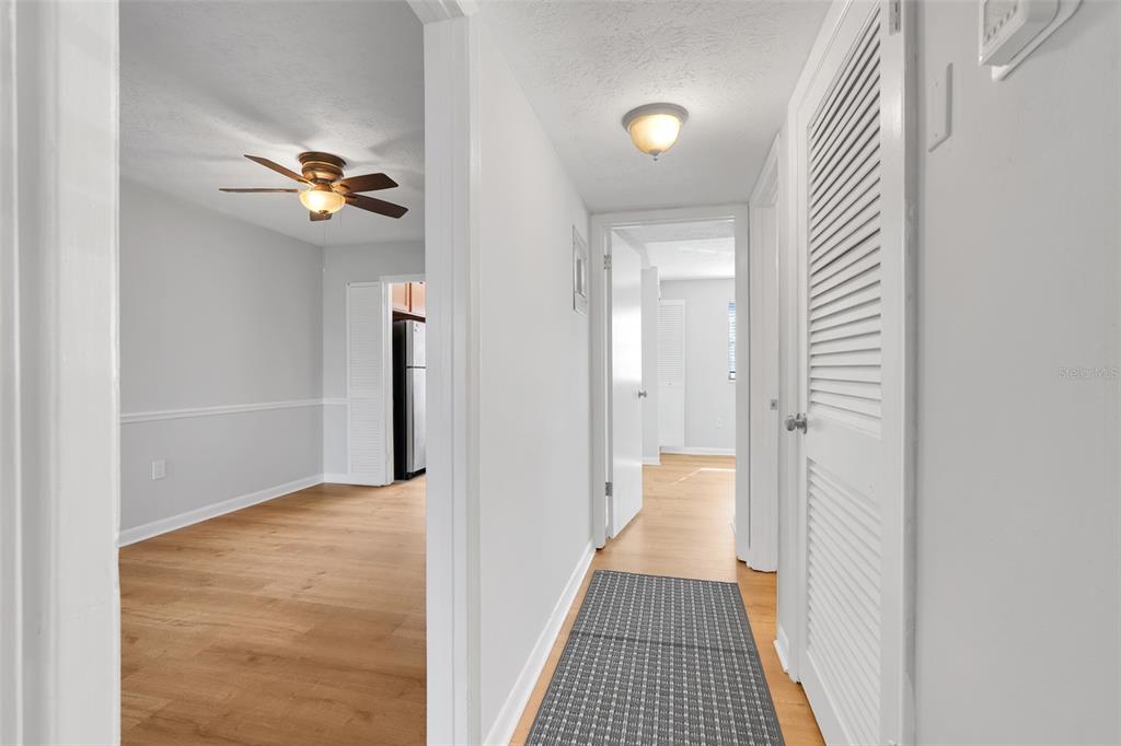 4312 Lake Underhill Road, Unit 19 Orlando, FL 32803 - Photo 11 of 43 a view of a hallway with wooden floor and a bathroom