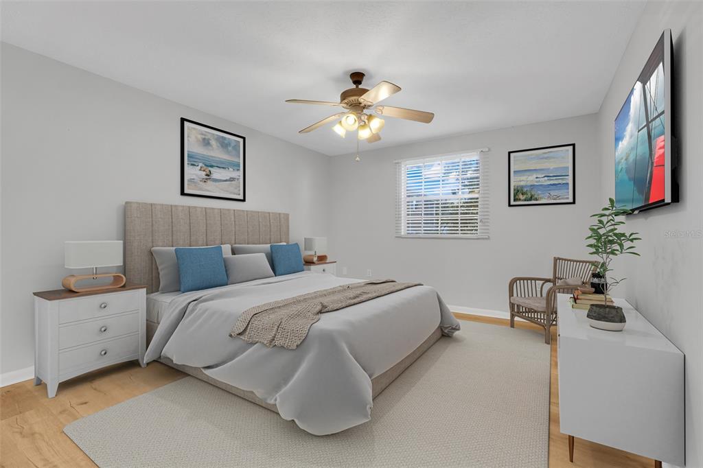 4312 Lake Underhill Road, Unit 19 Orlando, FL 32803 - Photo 13 of 43 a bedroom with a bed and a chandelier