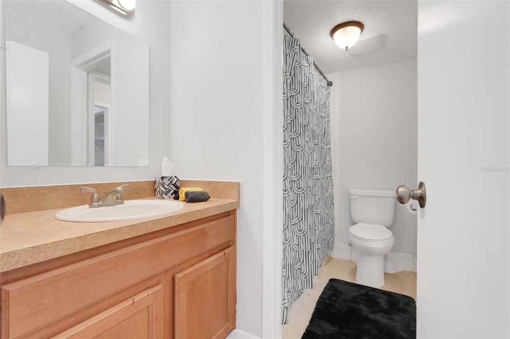 4312 Lake Underhill Road, Unit 19 Orlando, FL 32803 - Photo 17 of 43 a bathroom with a sink a toilet and a mirror