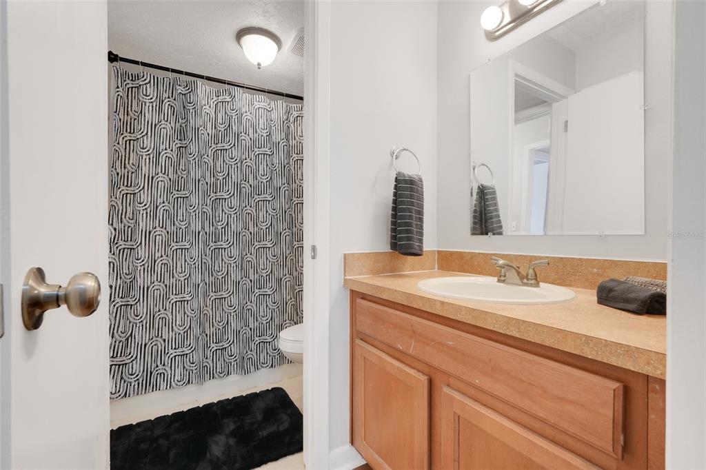 4312 Lake Underhill Road, Unit 19 Orlando, FL 32803 - Photo 18 of 43 a bathroom with a sink and mirror