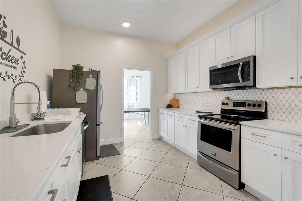 4312 Lake Underhill Road, Unit 19 Orlando, FL 32803 - Photo 31 of 43 a kitchen with stainless steel appliances granite countertop a sink and a stove