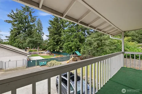 a view of a balcony with yard
