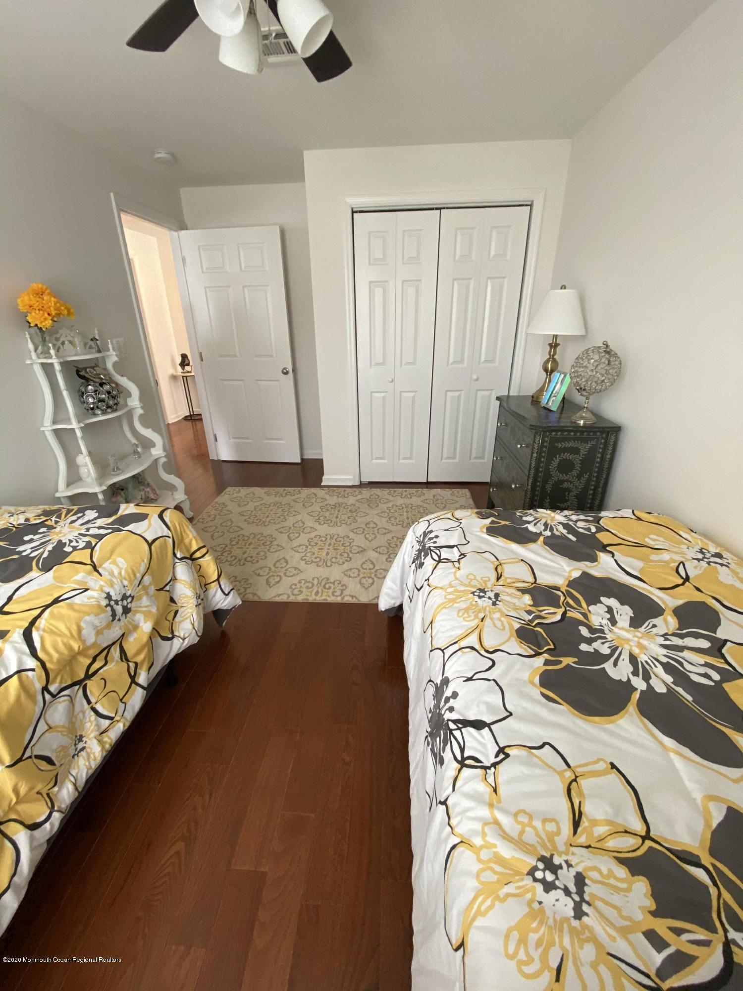 51 Gravelly Point Road Highlands, NJ 07732 - Photo 23 of 39 a bedroom with a bed and a chandelier