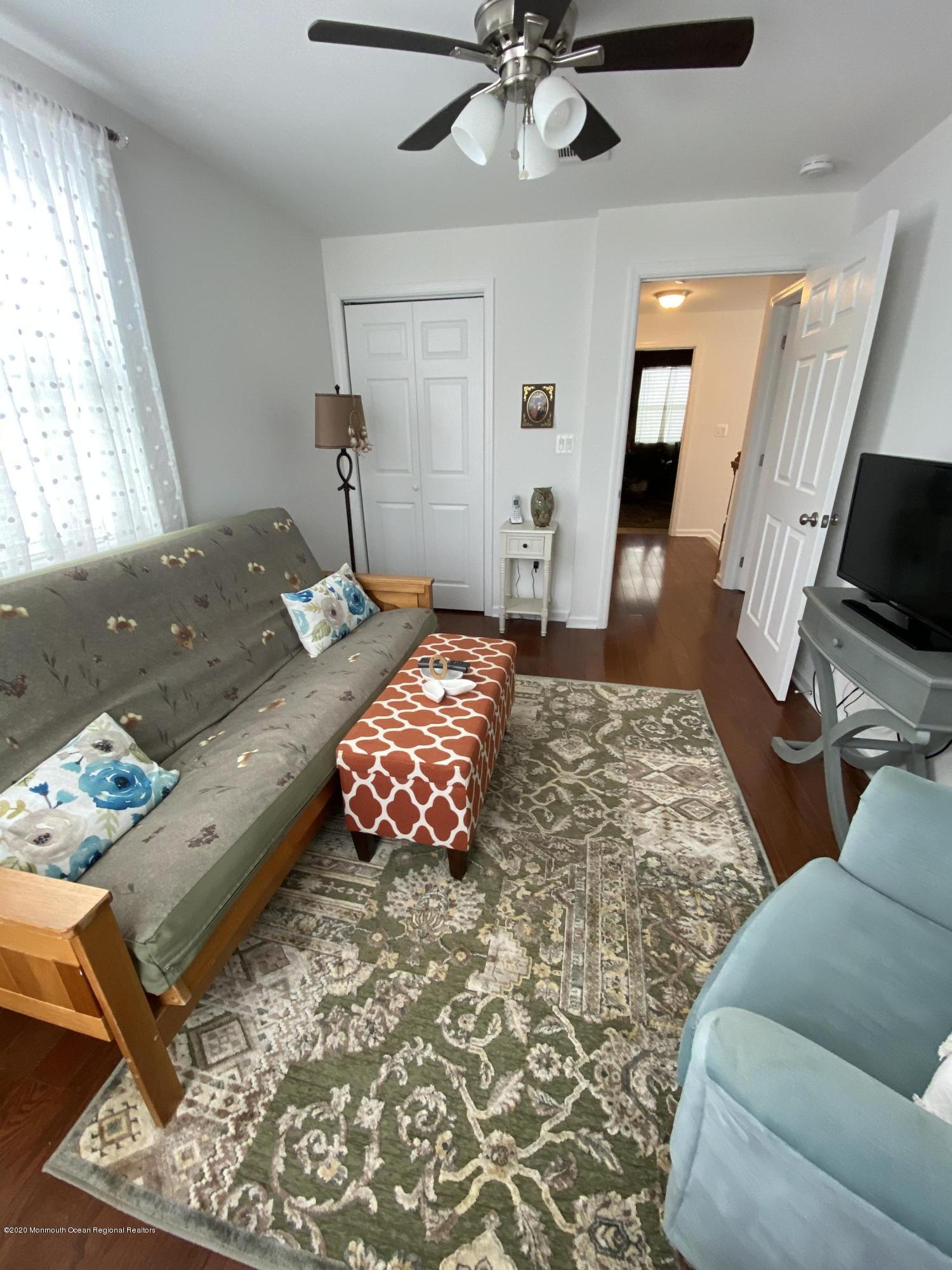 51 Gravelly Point Road Highlands, NJ 07732 - Photo 25 of 39 a bedroom with furniture and a flat screen tv