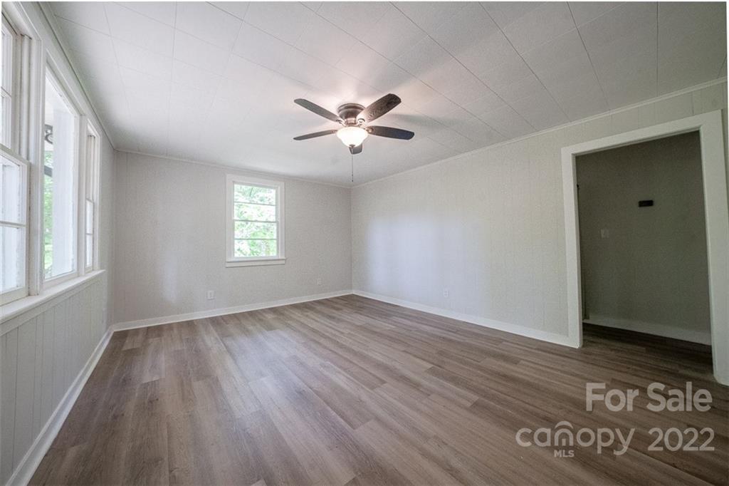 150 Archer Road Salisbury, NC 28147 - Photo 3 of 20 an empty room with wooden floor and windows