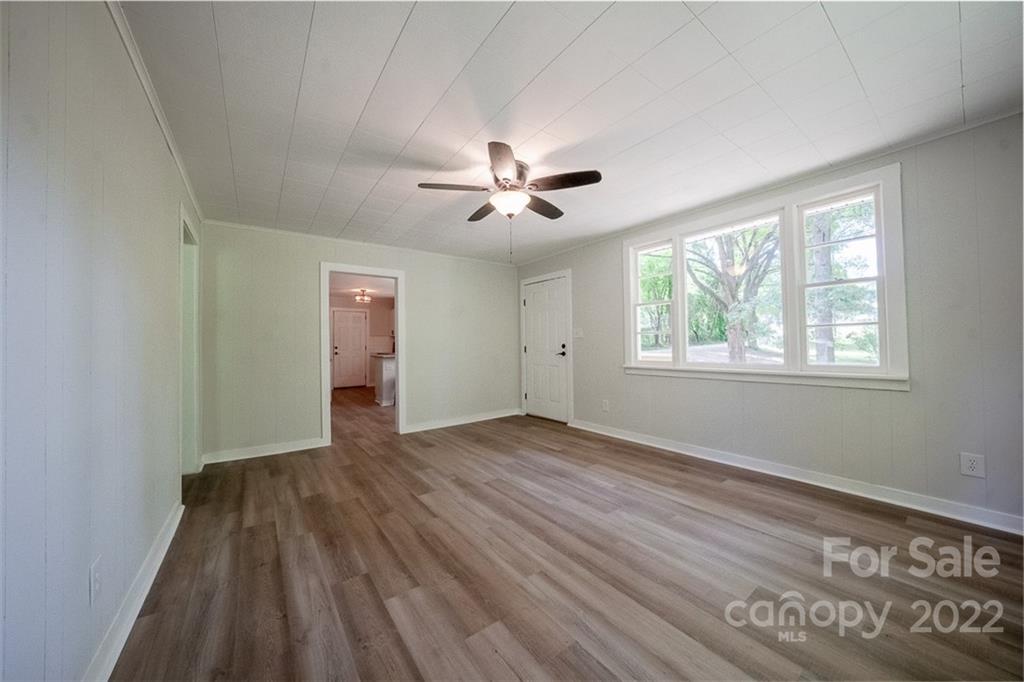150 Archer Road Salisbury, NC 28147 - Photo 4 of 20 a view of empty room with wooden floor and fan