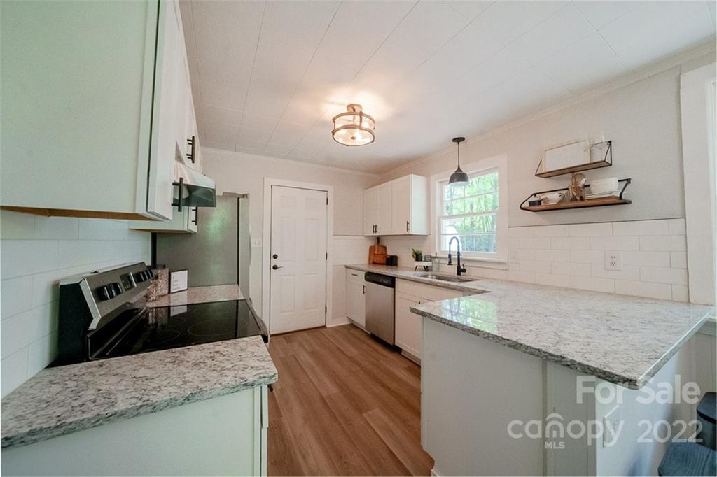 150 Archer Road Salisbury, NC 28147 - Photo 7 of 20 a kitchen with a sink stove and cabinets