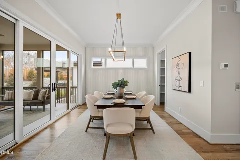a dining room with furniture wooden floor and a chandelier