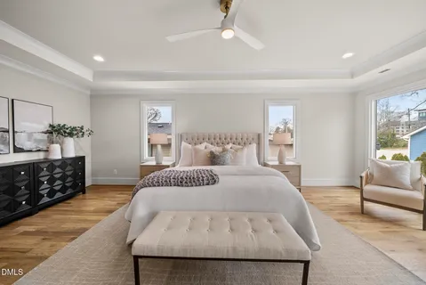 a bedroom with a large bed and a chandelier