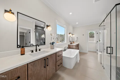a spacious bathroom with a double vanity sink mirror and toilet