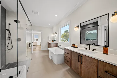 a bathroom with a double vanity sink a mirror and shower