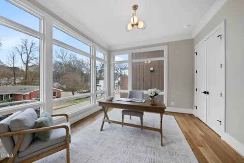 a room with pool table and windows