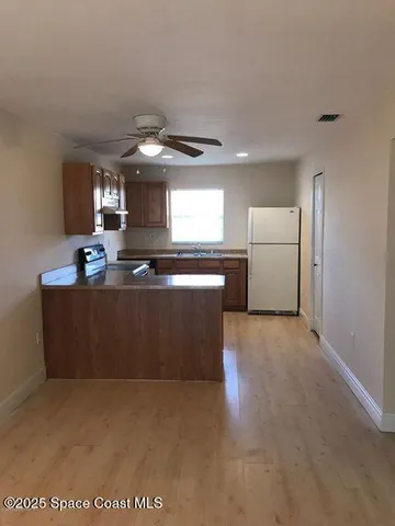 a kitchen with stainless steel appliances granite countertop a stove a sink a refrigerator and a microwave