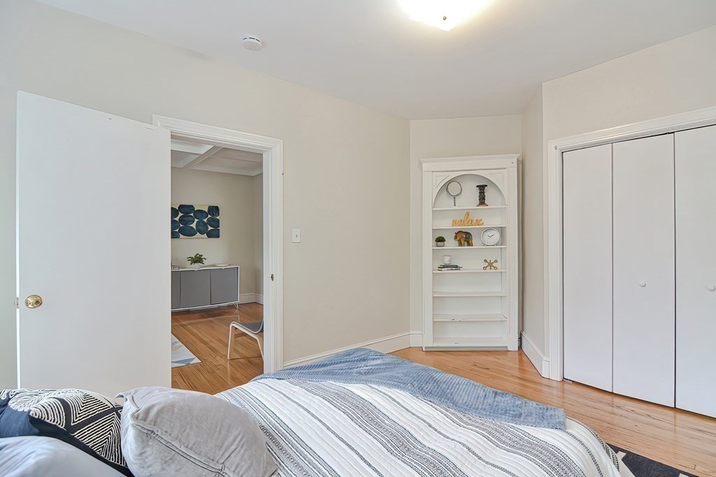 87 Broad Street, Unit 2 Lynn, MA 01902 - Photo 12 of 28 a bedroom with a bed and a couch