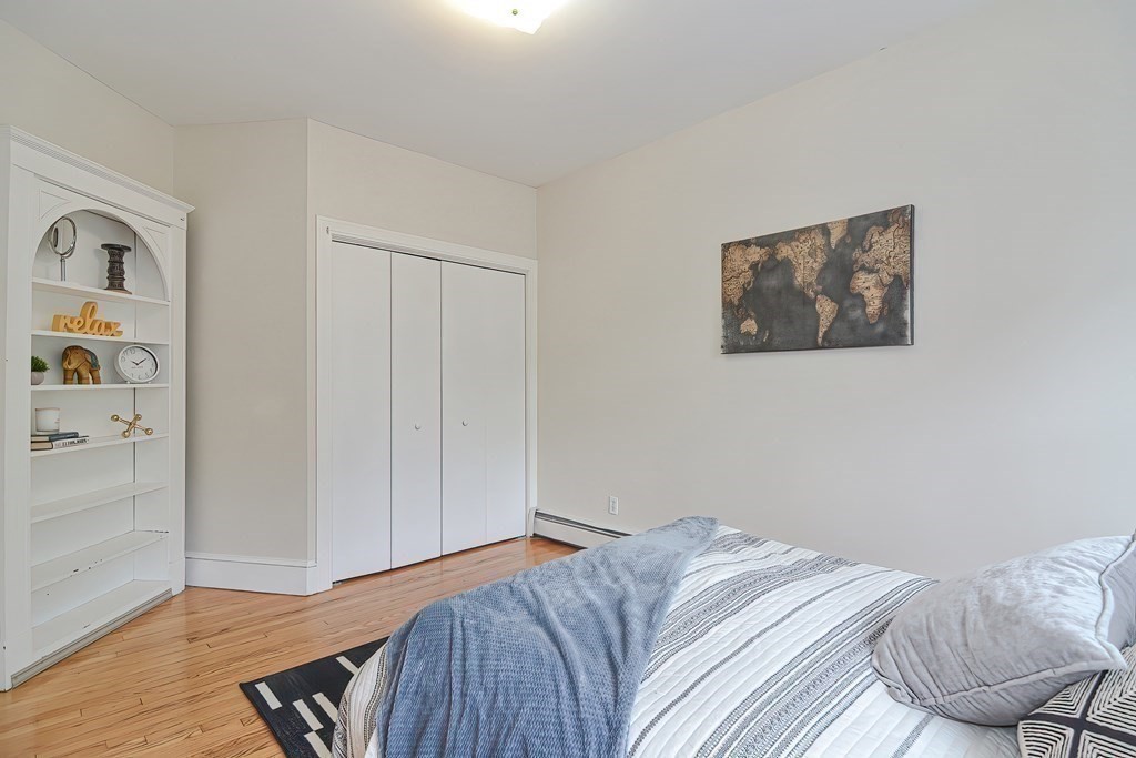 87 Broad Street, Unit 2 Lynn, MA 01902 - Photo 14 of 28 a bedroom with a bed and hallway