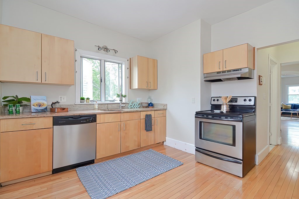 87 Broad Street, Unit 2 Lynn, MA 01902 - Photo 16 of 28 a kitchen with stainless steel appliances granite countertop a stove a sink and a refrigerator