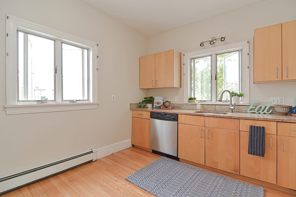 87 Broad Street, Unit 2 Lynn, MA 01902 - Photo 18 of 28 a kitchen with granite countertop a sink window and cabinets