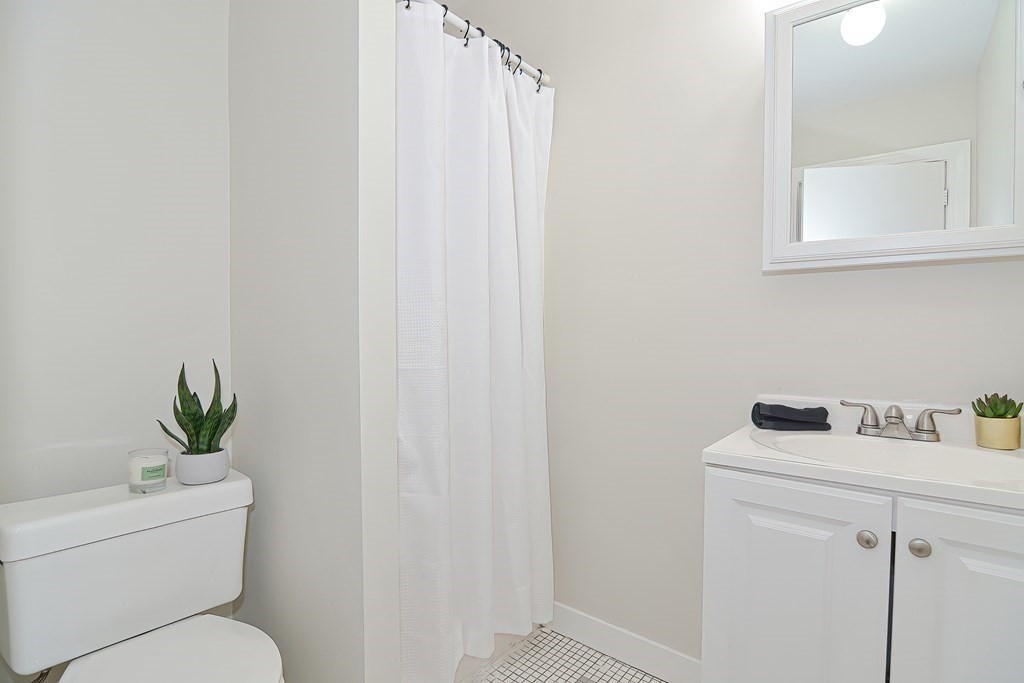 87 Broad Street, Unit 2 Lynn, MA 01902 - Photo 20 of 28 a bathroom with a toilet sink and vanity