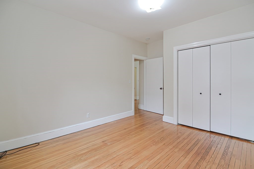 87 Broad Street, Unit 2 Lynn, MA 01902 - Photo 22 of 28 a view of an empty room with wooden floor