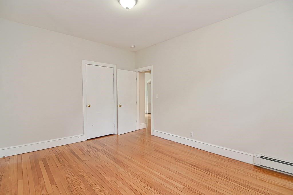 87 Broad Street, Unit 2 Lynn, MA 01902 - Photo 25 of 28 a view of an empty room with wooden floor