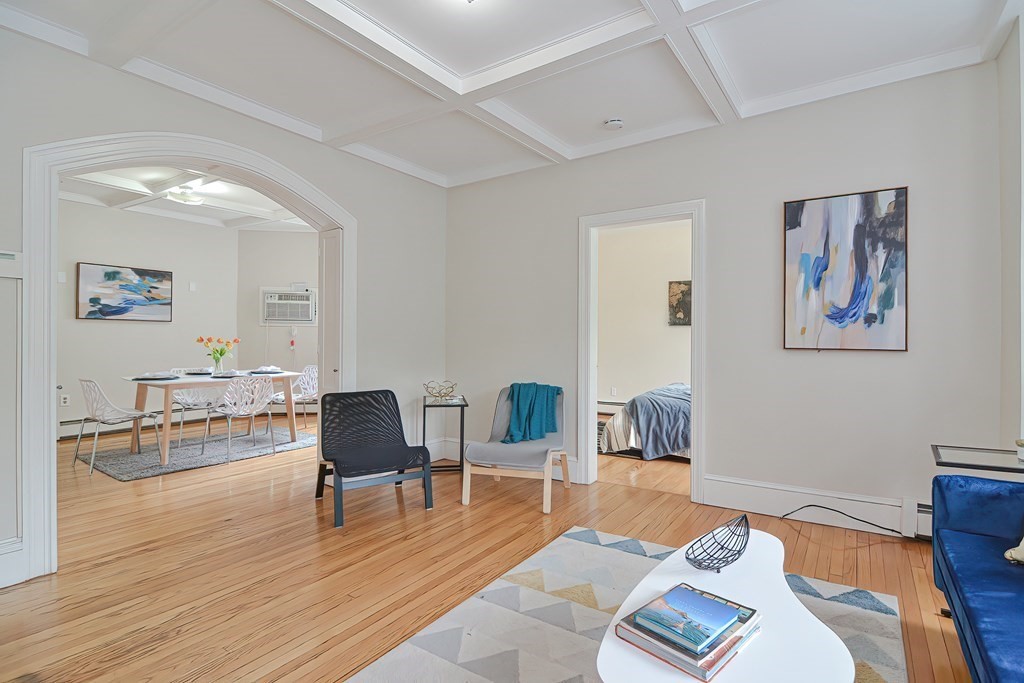 87 Broad Street, Unit 2 Lynn, MA 01902 - Photo 3 of 28 a living room with furniture and a wooden floor