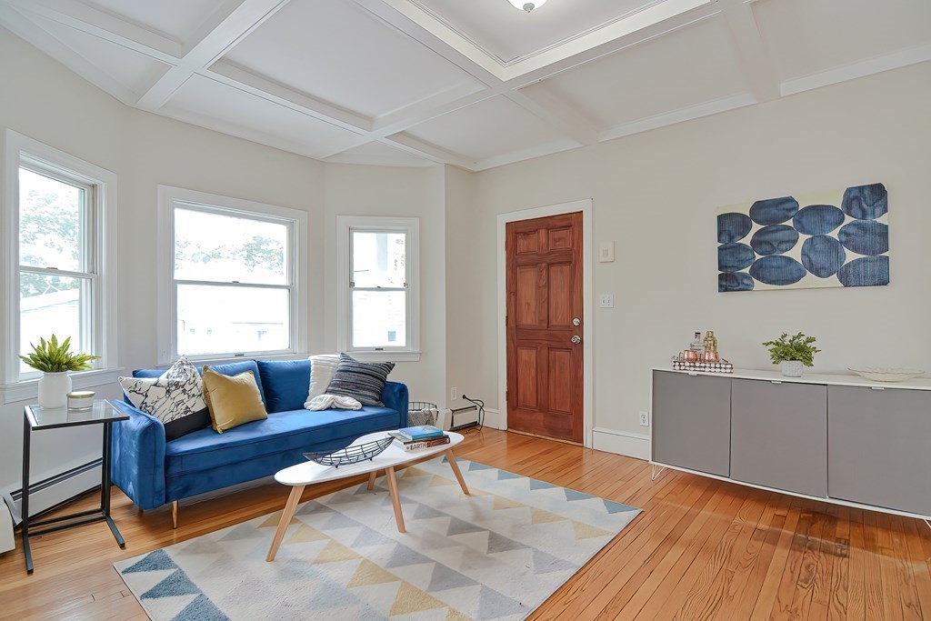 87 Broad Street, Unit 2 Lynn, MA 01902 - Photo 5 of 28 a living room with furniture and wooden floor