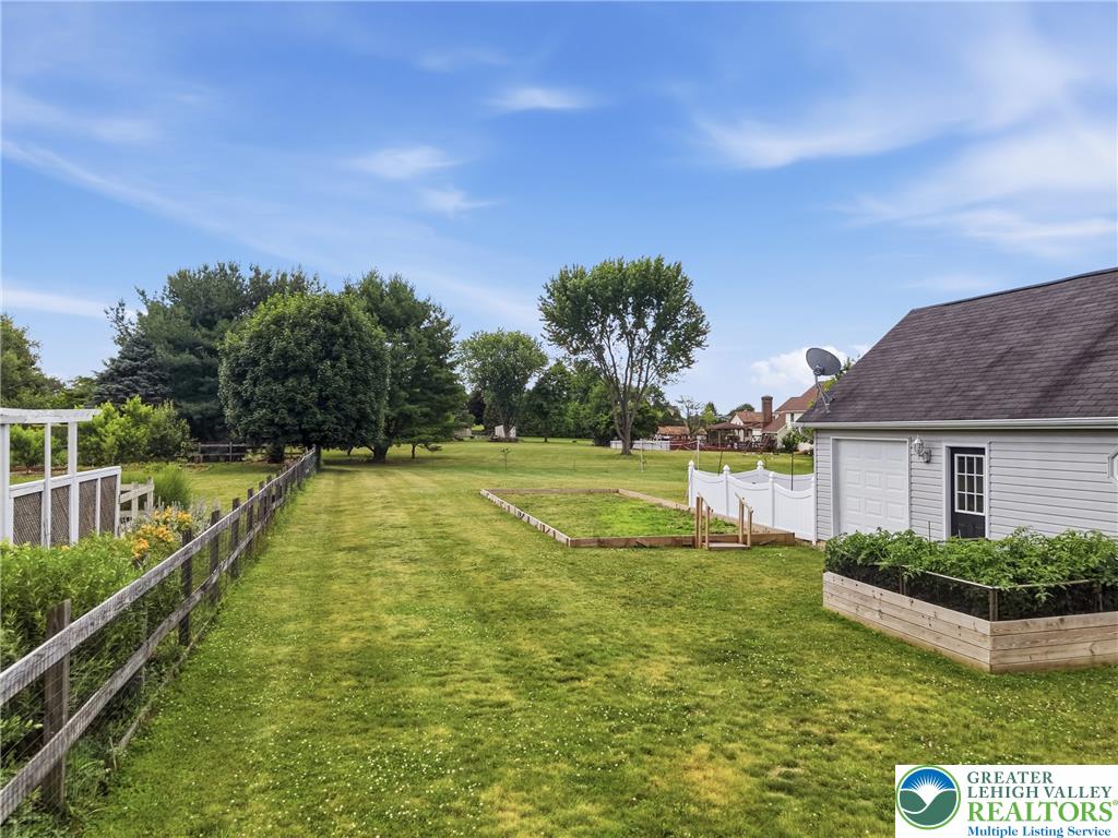 890 Lahr Road Nazareth, PA 18064 - Photo 68 of 71 A spacious yard with verdant lawns stretches toward a distant tree line, offering ample room for outdoor activities.
