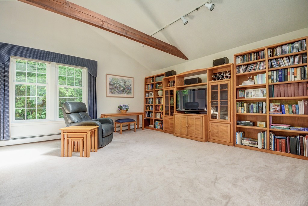 351 Liberty Square Road Boxborough, MA 01719 - Photo 14 of 30 a living room with furniture cabinets and a book shelf