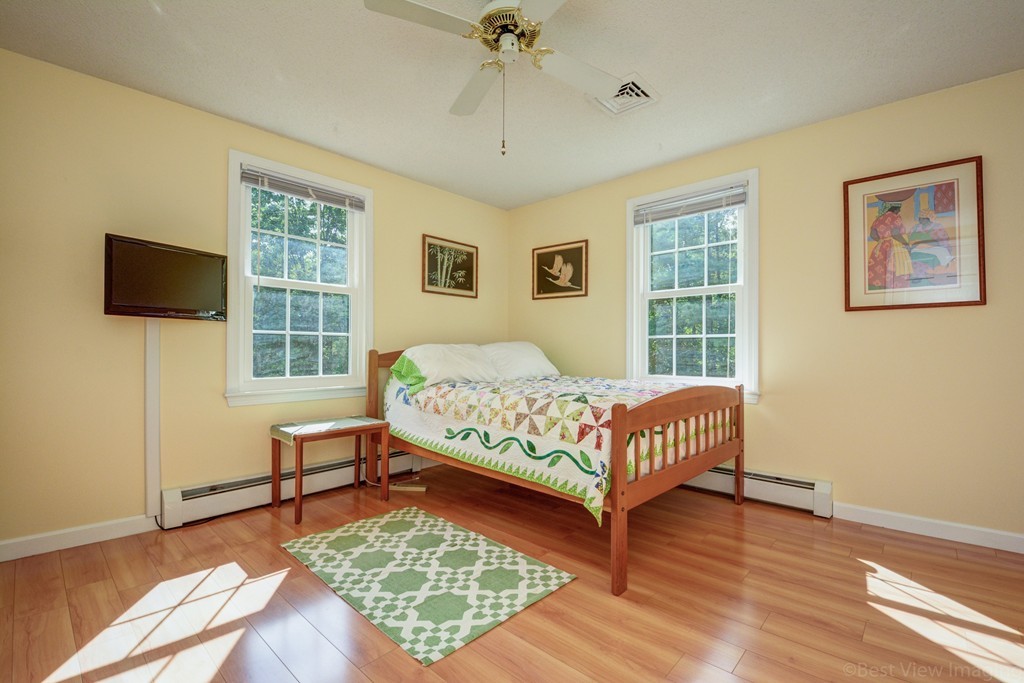 351 Liberty Square Road Boxborough, MA 01719 - Photo 22 of 30 a bedroom with a bed window and a flat screen tv