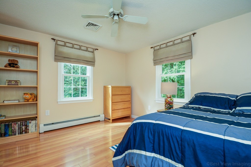 351 Liberty Square Road Boxborough, MA 01719 - Photo 23 of 30 a bedroom with a bed and a dresser