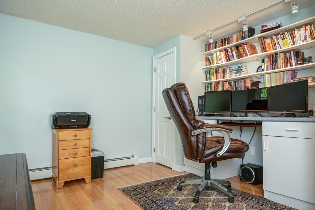 351 Liberty Square Road Boxborough, MA 01719 - Photo 24 of 30 a view of a workspace with furniture and wooden floor