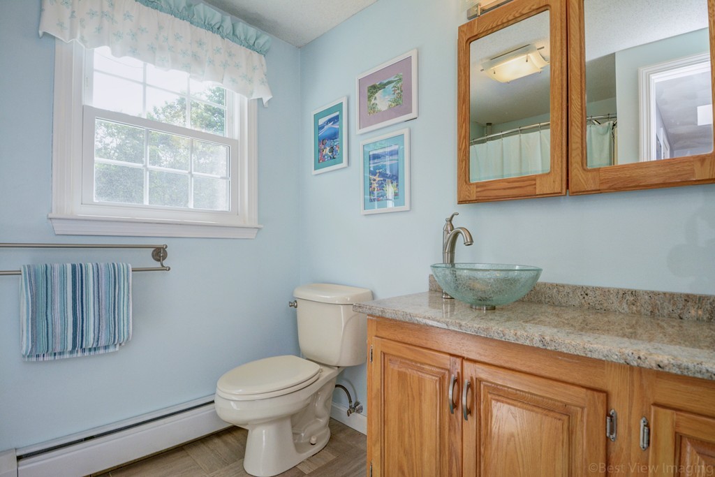 351 Liberty Square Road Boxborough, MA 01719 - Photo 25 of 30 a bathroom with a granite countertop toilet sink and mirror