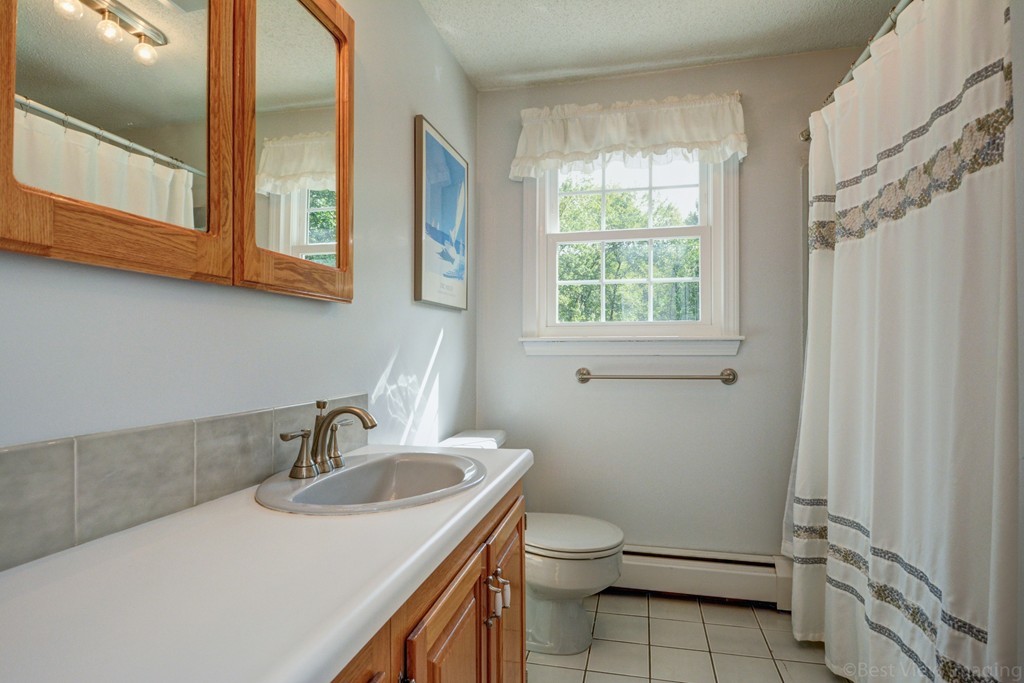 351 Liberty Square Road Boxborough, MA 01719 - Photo 27 of 30 a bathroom with a sink a toilet and a window