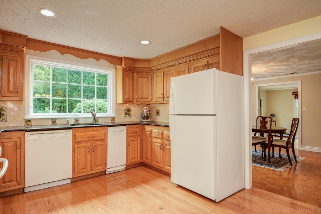 351 Liberty Square Road Boxborough, MA 01719 - Photo 5 of 30 a kitchen with stainless steel appliances granite countertop a refrigerator and a stove top oven