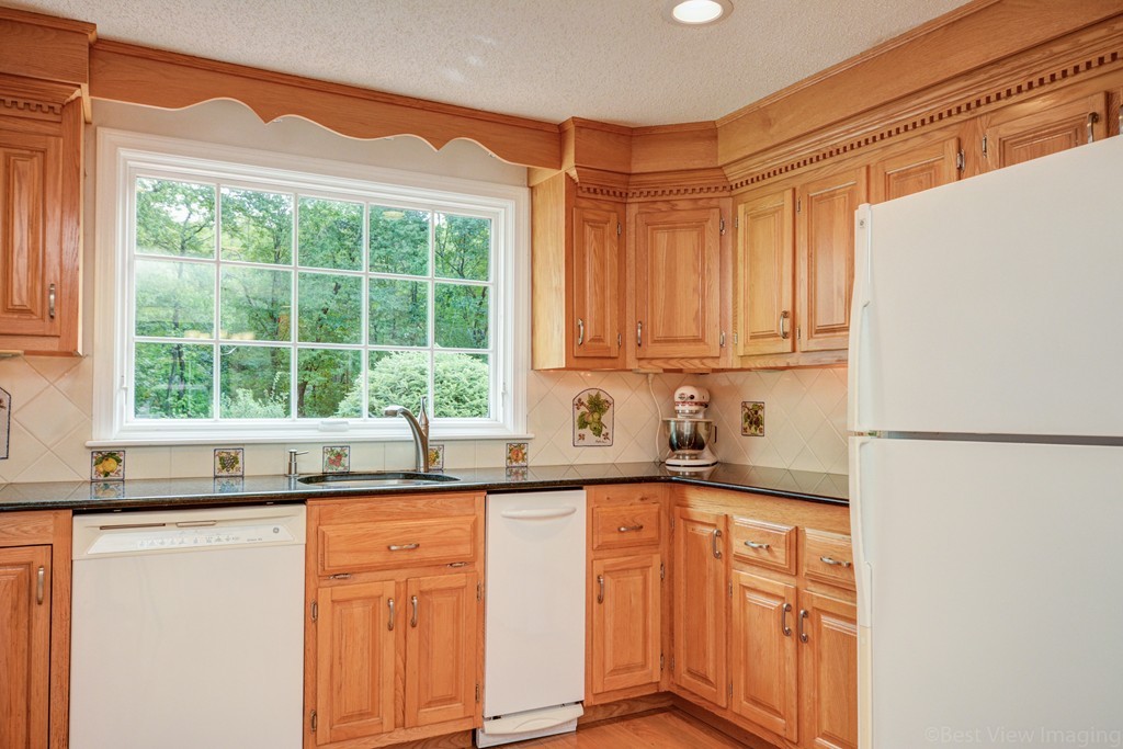 351 Liberty Square Road Boxborough, MA 01719 - Photo 6 of 30 a kitchen with stainless steel appliances granite countertop a refrigerator and a sink