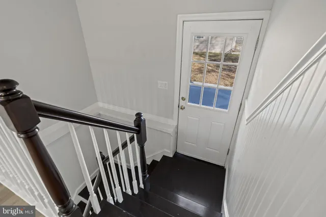 a view of an entryway with wooden floor