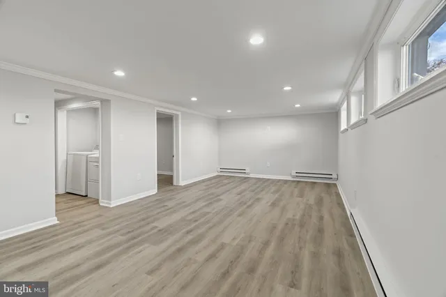 a view of an empty room with wooden floor