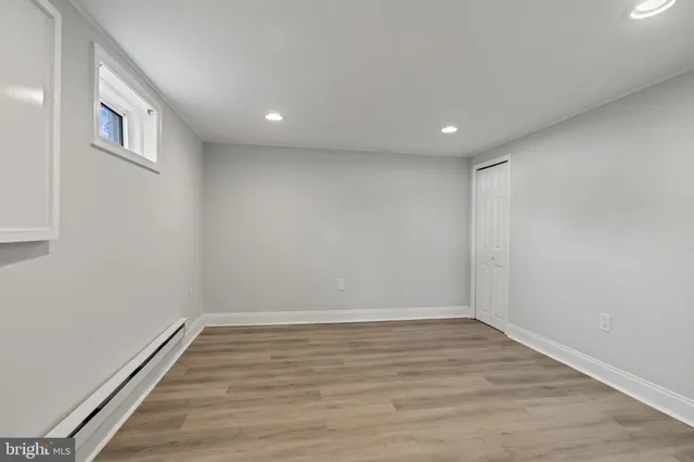 a view of room with window and wooden floor