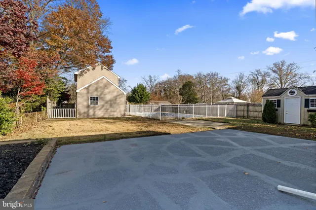a view of an house with swimming pool and a yard