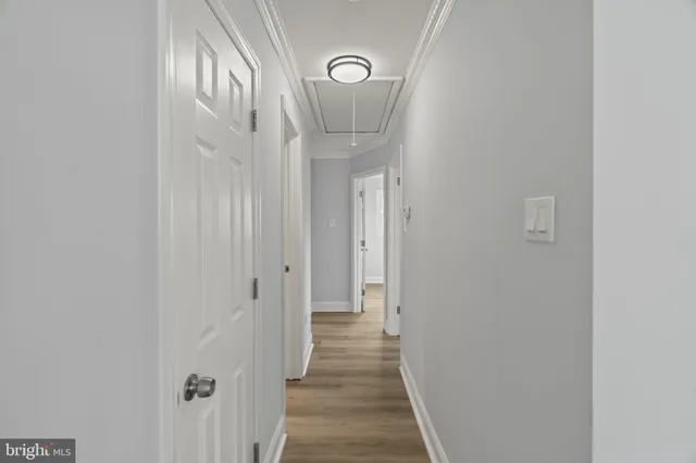 a view of a hallway with wooden floor