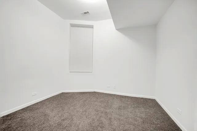 a view of a big room with closet and windows