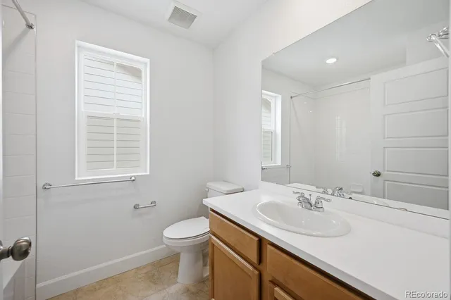 a bathroom with a sink toilet and a mirror