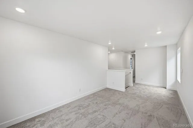 an empty room with a kitchen