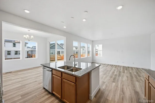 a kitchen with granite countertop a stove and a sink