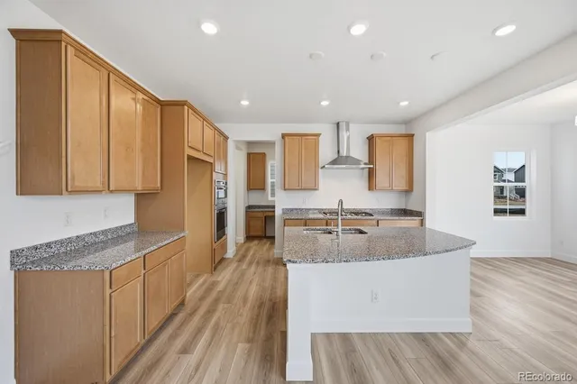 a large kitchen with stainless steel appliances granite countertop a lot of counter space and a sink