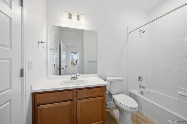 a bathroom with a sink toilet a mirror and shower
