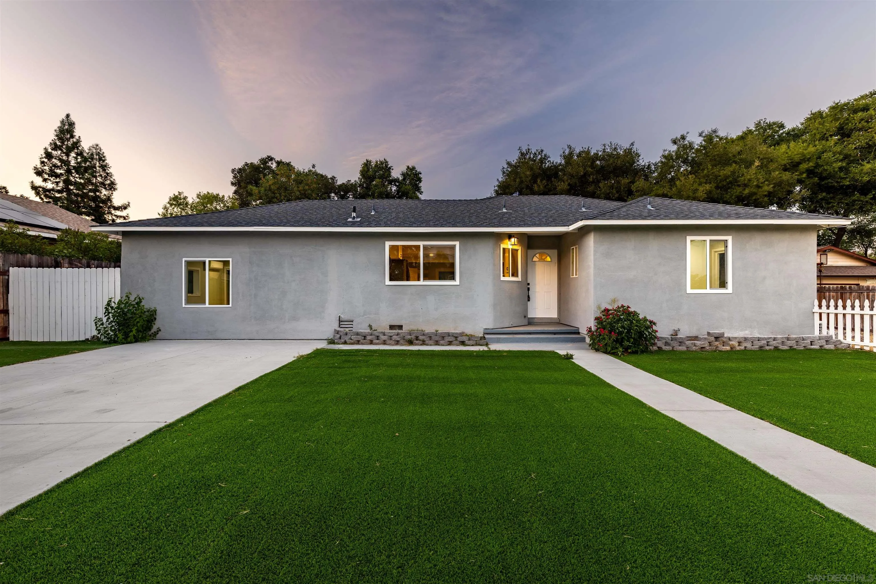 a front view of a house with a garden